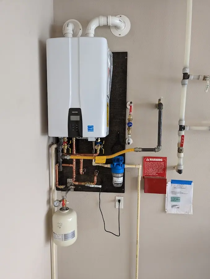 Professional plumber installing copper piping in a Glastonbury home